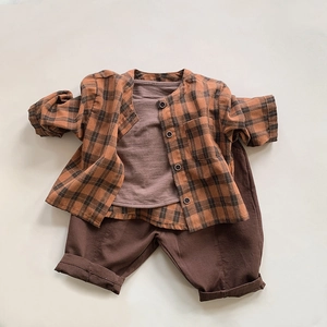 Flat lay of vintage style kids plaid shirt with brown t-shirt and casual jogger pants