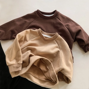 Detail of soft fleece lining inside kids crewneck sweatshirts in brown and khaki