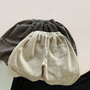 Flat lay of loose cotton knit kids harem pants in dark grey and beige colors