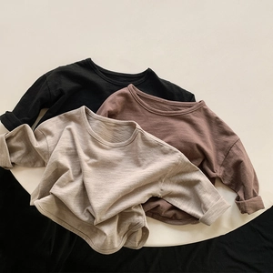 Detailed texture of cotton long sleeve shirts in earth tones with rolled cuffs