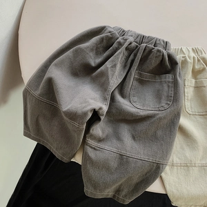 Detail of loose fit cotton kids harem pants with elastic waistband and large back pockets