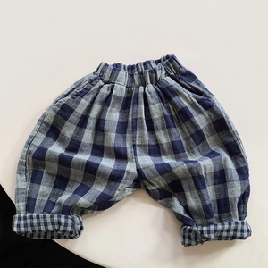 Detailed view of kids vintage blue plaid pants featuring elastic waist and rolled cuffs
