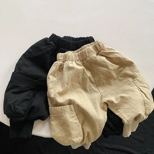 Detail of kids cargo pants with elastic waist and large side pockets in black and khaki