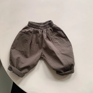 Detail of children's cotton pants showing elastic waistband and side pocket texture