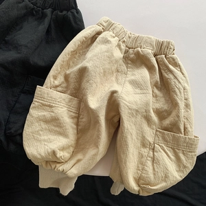 Detail of kids cotton cargo pants with elastic waist and large side pockets