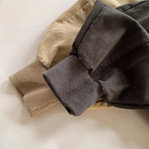 Détail des poignets côtelés sur des pantalons décontractés pour enfants kaki et gris
