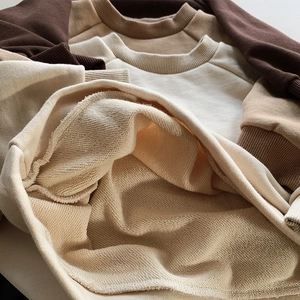 Macro shot of high-quality French Terry knit texture on earthy brown cotton sweatshirts