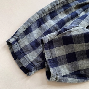 Close-up of blue plaid double-layer cotton kids pants showing elastic ankle cuff detail