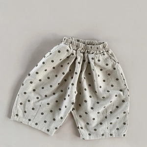 Detailed texture of cotton linen polka dot shorts with an elastic waist for kids