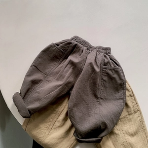 Detailed texture of cotton linen kids loose pants with elastic waist and deep pockets