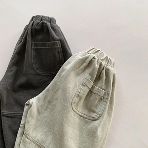 Detail view of elastic waist and back pocket on kids loose fit Harem pants with double stitching