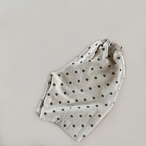 Detailed view of elastic waistband and polka dot texture on cotton linen kids shorts