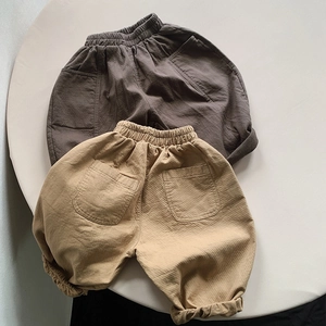Detailed macro view of pure cotton kids pants showing fabric texture and back pockets
