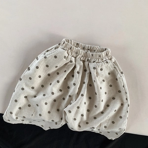 Detail view of cotton linen kids polka dot shorts with elastic waistband and rolled hems