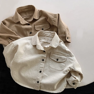 Detailed flat lay of children's cotton canvas shirts in khaki and beige tones