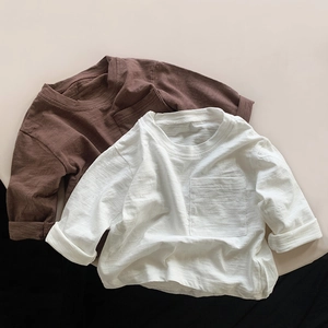 Detailed texture of kids bamboo cotton long sleeve shirts with round neck and chest pocket