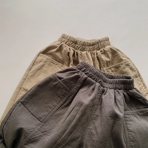 Flat lay detail of cotton loose trousers with elastic waist and cargo side pockets