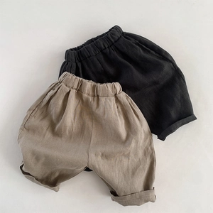 Detailed fabric texture of kids linen shorts with elastic waistband and rolled cuffs