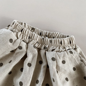 Detail view of cotton linen polka dot kids shorts featuring elastic waist and side pocket