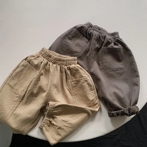 Detail showing elastic waistband and high-density cotton texture on kids' casual pants