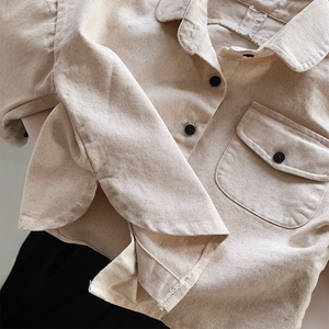 Detail of premium heavy cotton children shirt featuring black buttons and textured fabric