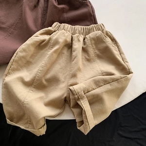 Detail view of kids loose cotton shorts with comfortable elastic waistband and side pockets