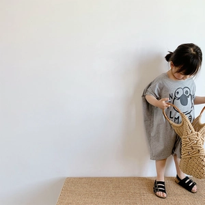 Detail of grey cotton baby romper with cartoon print and soft knit texture