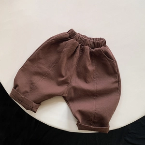 Close-up of brown casual harem pants featuring elastic drawstring waist and side pockets
