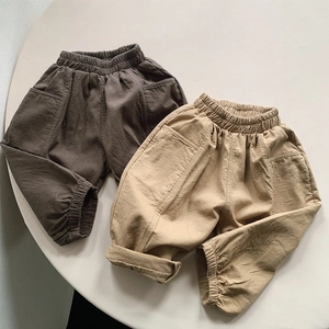 Detail of cotton kids' casual pants showing elastic waist and large side pockets