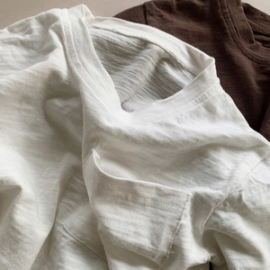 Close-up detail of slub cotton texture and ribbed crew neck on kids' casual T-shirts