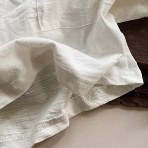Children's white slub cotton long sleeve T-shirt with breathable texture and pocket details