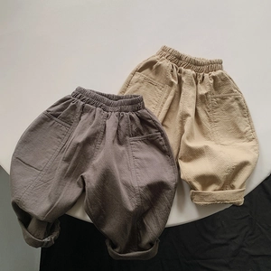 Flat lay of cotton kids harem pants with elastic high waist and large side pockets