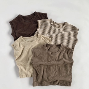 Detailed close-up of breathable slub cotton texture on various kids sleeveless vests