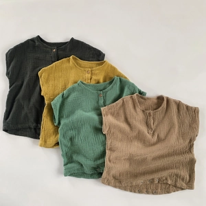 Detail of baby cotton gauze rompers showing breathable texture in four earthy colors