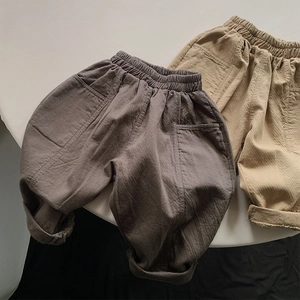 Detailed macro view of pure cotton breathable children harem pants in brown and khaki tones