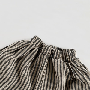 Detail of high-waisted elastic waistband on striped cotton linen shorts for children