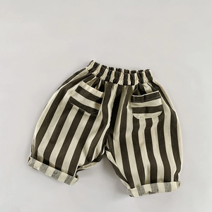 Detail of kids striped cotton linen trousers featuring elastic waist and square pockets