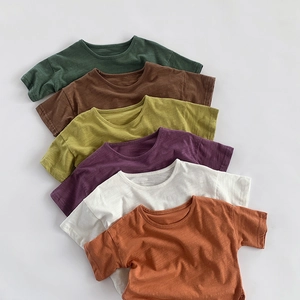 Close-up of bamboo cotton kids' T-shirts showing fabric texture in multiple earth tones