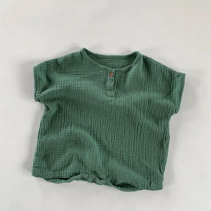 Detailed macro view of breathable double-layer cotton gauze baby romper fabric in dark green