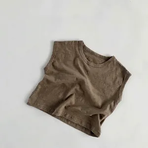 Detailed view of dark brown slub cotton fabric texture on children's breathable tank top