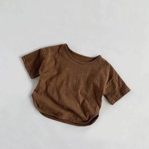 Close-up of brown bamboo cotton kids t-shirt showing round neck and curved hem texture
