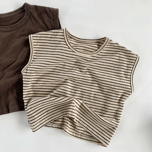 Detail of breathable slub cotton kids vests in solid brown and striped beige patterns