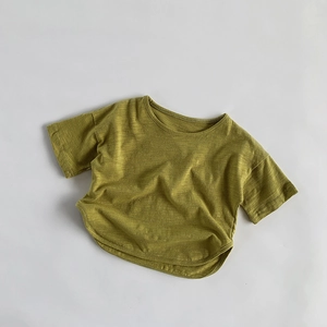 Detailed flat lay of grass green slub cotton T-shirt showing natural fabric texture