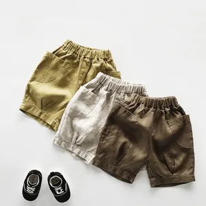 Détails de shorts en lin en gingembre, avoine et marron avec de grandes poches rondes