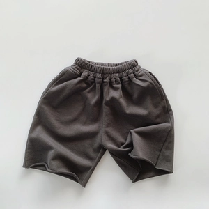 Detail view of dark grey kids cotton shorts showing elastic waistband and terry fabric