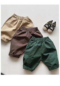 Flat lay of cotton elastic waist casual pants for kids in khaki, brown, and dark green