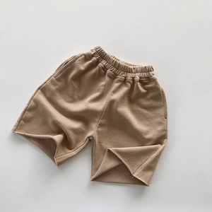 Detailed texture of khaki cotton French Terry fabric on kids leisure shorts with elastic waist