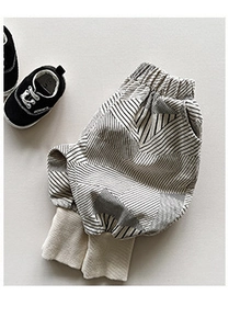 Detail of baby striped joggers featuring wide ribbed cuffs and soft cotton texture
