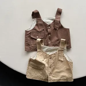 Close-up of cotton linen vests with wooden buttons and utility pockets for kids