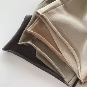 Detailed macro view of four low-saturation colors in premium soft knitted cotton fabric